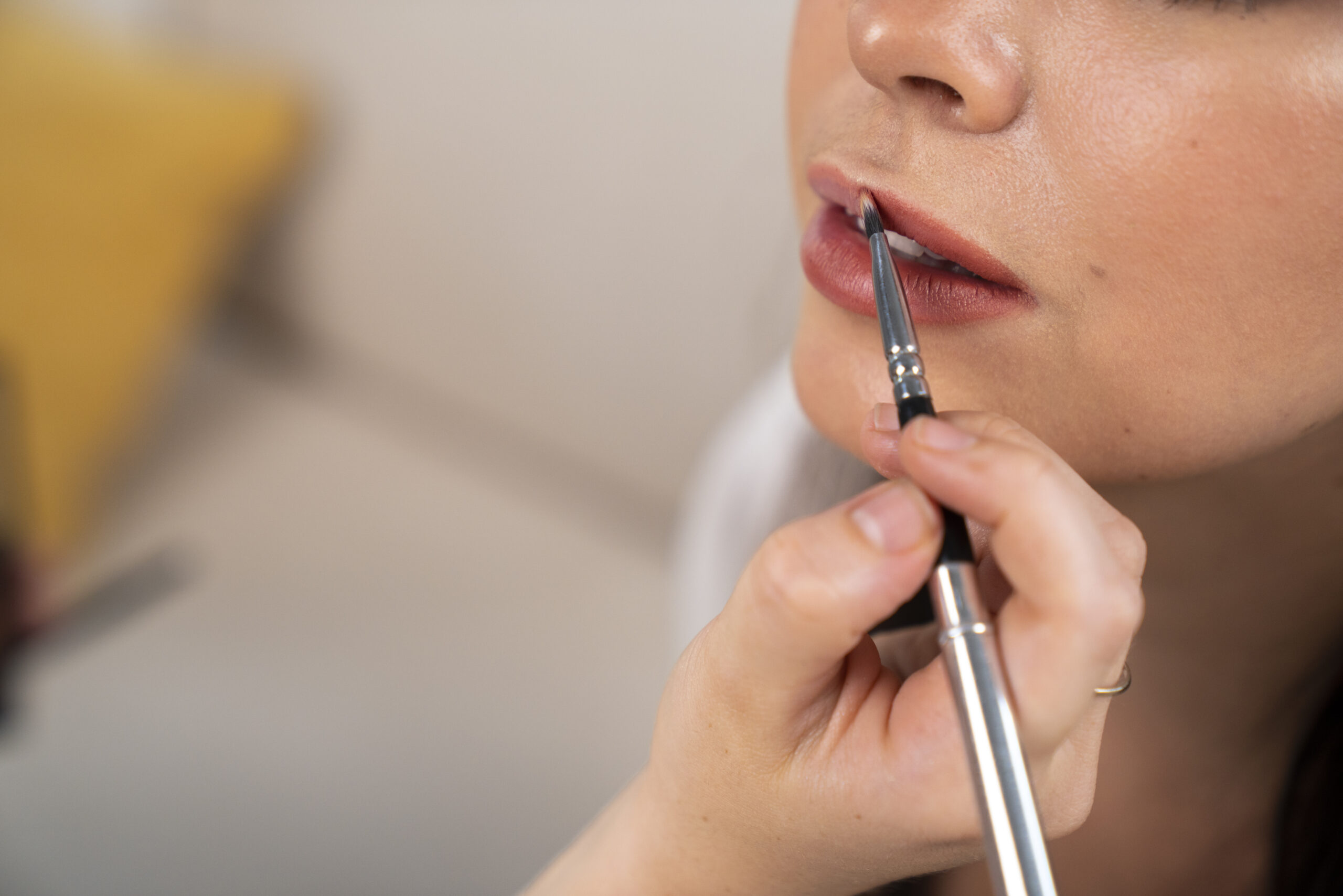 side-view-hand-holding-lip-brush